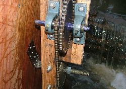 Roller chain and hardened sprockets used to gear up RPM of waterwheel